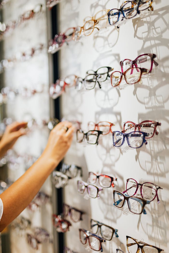 services-01 A vibrant selection of eyeglasses in various styles on display at an optical store.